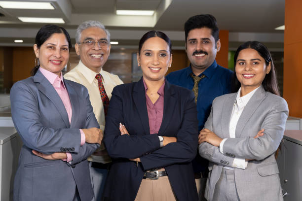 Successful group of business people at the office looking at the camera smiling.